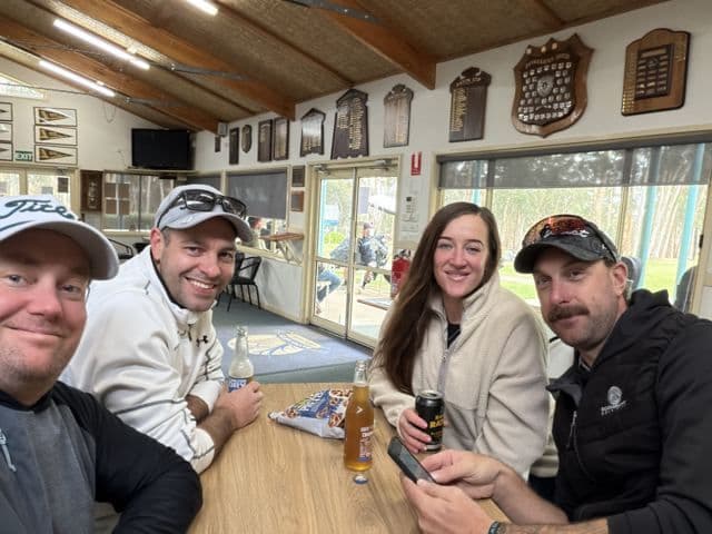 Four players with a drink in the clubhouse