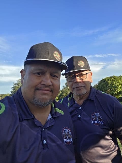 Two players in matching polos on the course