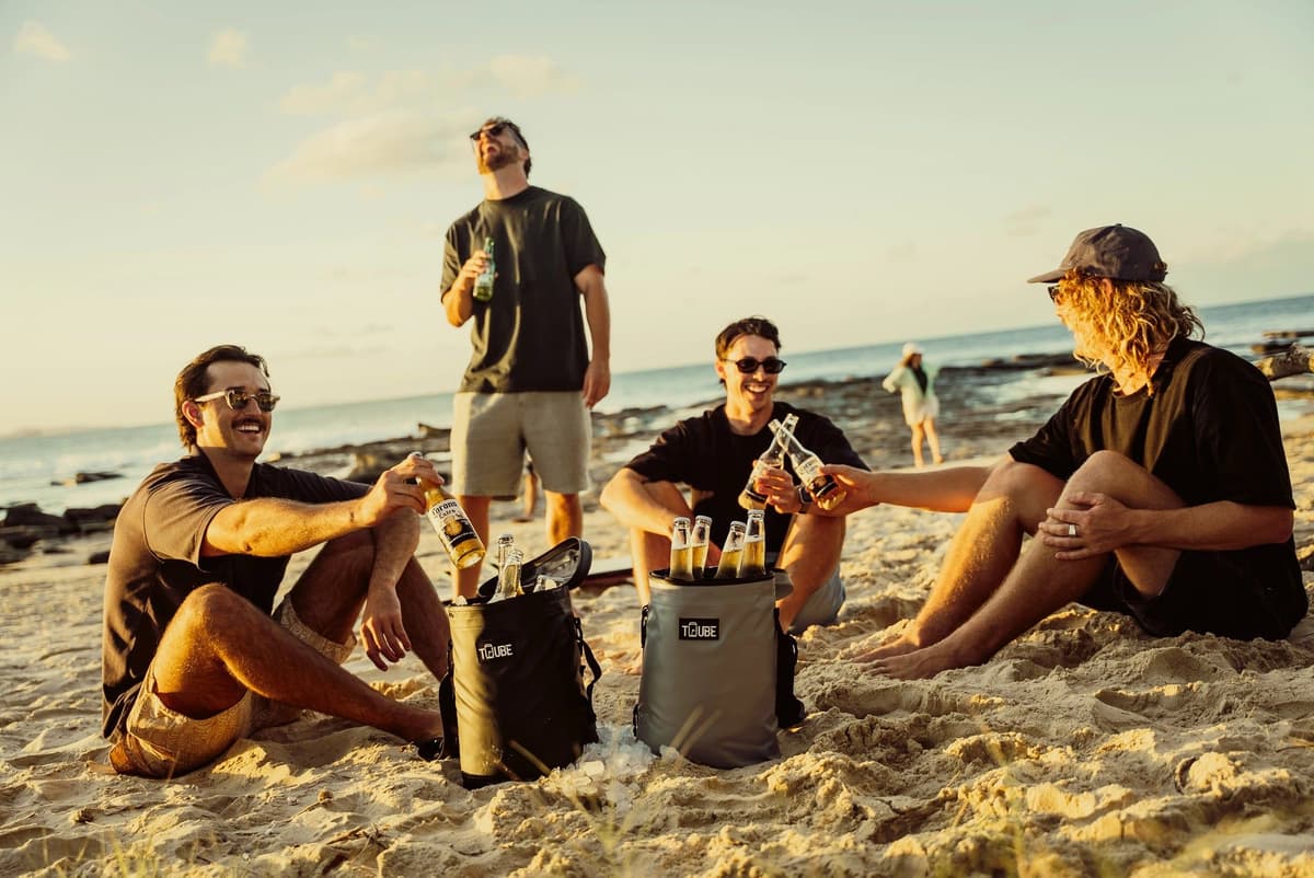 Mates on the beach at sunset with their coolers